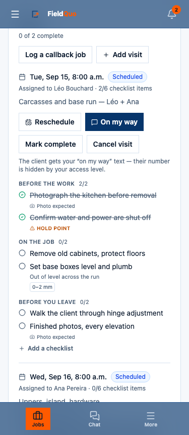 A job on a phone — the visit with its On my way and Mark complete buttons, the checklist underneath, and the Jobs · Chat · More tab bar.